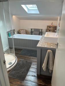 ein Badezimmer mit Badewanne und Waschbecken in der Unterkunft Bramble Cottage on the edge of Exmoor in Combe Martin