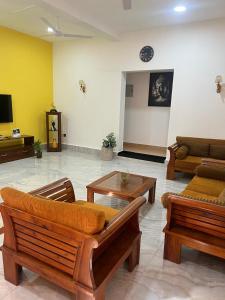 a living room with couches and a coffee table at Wilson's Guest House in Nilwella
