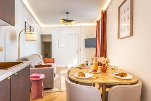 a kitchen and dining room with a table and chairs at Modern Souplex with Air Conditioning and Hot Tub I Central location in Paris