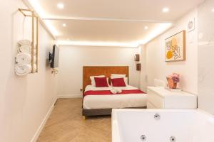 a bedroom with a bed and a bath tub at Modern Souplex with Air Conditioning and Hot Tub I Central location in Paris