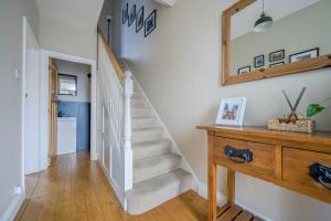 a staircase in a home with a mirror on the wall at Grove Getaway Walk To The Beach & Ballyholme in Bangor