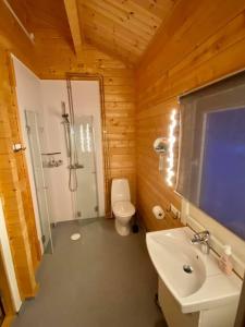 a bathroom with a white sink and a toilet at Offroadcamp in Sörsjön +57 photos