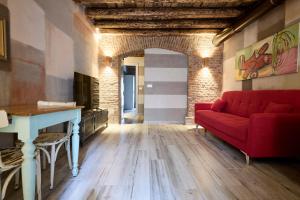 a living room with a red couch and a table at Emme Loft I New Moon - Stylish Apartment with Balcony in Milan