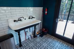 a bathroom with a sink and a tile floor at Chic Catskills Farmhouse in Harris +27 photos