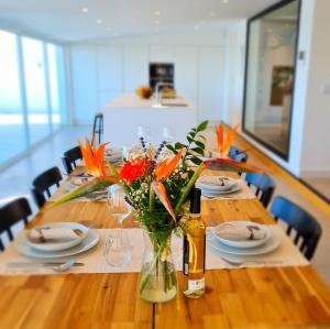 a long wooden table with a vase of flowers on it at Cachito de Cielo in La Victoria de Acentejo