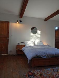 a bedroom with a bed with a blue comforter at Chez Olive et Garance in Couret +23 photos