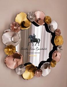 a wreath of different colored cupcakes on a wall at Salotto Corso Garibaldi in Piacenza