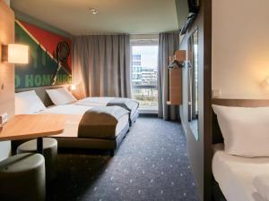 Postel nebo postele na pokoji v ubytování B&B Hotel Bad Homburg