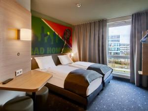 Postel nebo postele na pokoji v ubytování B&B Hotel Bad Homburg