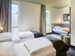 Postel nebo postele na pokoji v ubytování B&B Hotel Bad Homburg