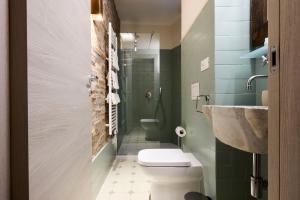 a bathroom with a toilet and a sink at Emme Loft I Flower Moon - Boutique Loft with Jacuzzi in Milan