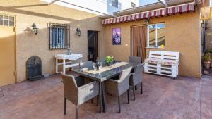 a patio with a table and chairs and a building at La Fuente Romana Priego de Córdoba by Ruralidays in Priego de Córdoba