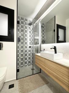a bathroom with a sink and a shower at Cozy Apartment with Acropolis View Rooftop Access in Athens
