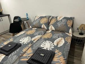 a couch with a blanket and two bags on it at Cherry Street Apartment in Wolsztyn