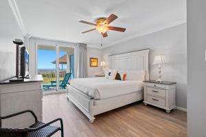a bedroom with a bed and a ceiling fan at Romar Tower Unit 1A in Orange Beach