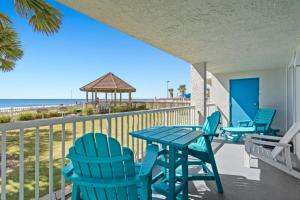 a table and chairs on a balcony with the beach at Romar Tower Unit 1A in Orange Beach