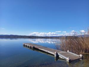 a dock in the middle of a lake at Casa Vacanze La Favola Rosa sul Lago di Varese in Gavirate