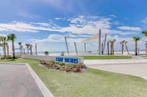 a sign that reads off hooks in front of the beach at Beachview Unit 321 in Gulf Shores