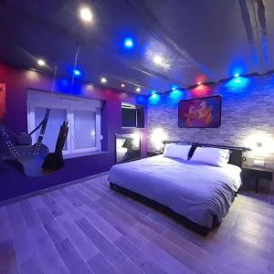 a bedroom with a bed and a brick wall at L'art du désir in Le Saulcy +25 photos
