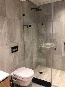 a bathroom with a shower and a toilet and a sink at 601 The Cosmopolitan in Cape Town