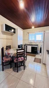 a kitchen with a table and chairs in a room at Casa na serra in Campos do Jordão