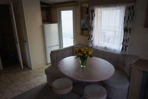 a living room with a table with a vase of flowers on it at Kota Kiva in Hulshorst +29 photos