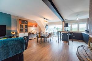 a kitchen and living room with a table and chairs at Maison avec terrasse proche plage et port de Binic in Binic-Etables-sur-Mer