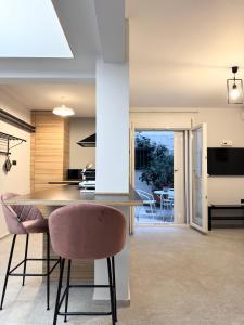 a kitchen and dining room with a table and chairs at Cozy Apartment with Acropolis View Rooftop Access in Athens