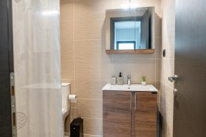 a bathroom with a sink and a mirror at Callas Home in Kos +39 photos