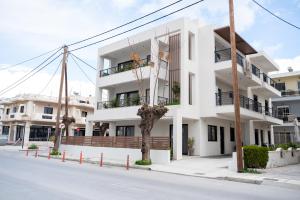 a white building on the side of a street at Callas Home in Kos