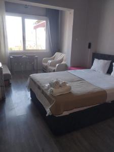 a hotel room with a bed with towels on it at Palmiye Pansiyon in Adalar