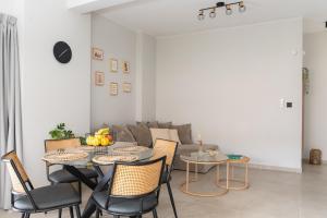 a living room with a table and chairs and a couch at Callas Home in Kos