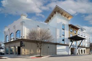 a white building on the corner of a street at Sol Cypress, San Antonio, a Tribute Portfolio Hotel in San Antonio