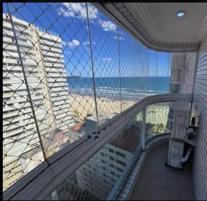 a view of the beach from a balcony of a building at AP beira mar in Praia Grande