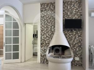 a fireplace in a room with a tv on a wall at Villa Desiderio By Cala Salento in Torre Lapillo +73 photos