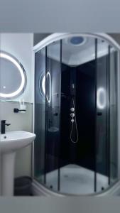 a bathroom with a glass shower with a sink at Sweet Apple Garden in Almaty +91 photos
