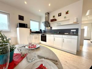 a kitchen with a table with a plate of food on it at Ferienwohnung Linda in Lenz +10 photos