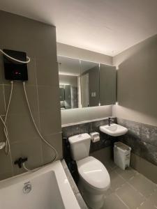 a bathroom with a toilet and a sink at Elegant Escape Milano Bacoor Cavite in Bacoor +35 photos