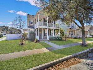 a large white house with a tree in front of it at Coastal Quarters in Bluffton
