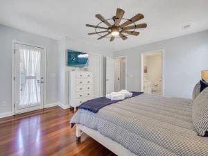 a bedroom with a bed and a ceiling fan at Coastal Quarters in Bluffton +28 photos