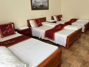 a group of four beds in a room at Công Thành hotel in Lao Cai
