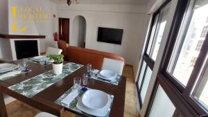 a dining room with a table and a couch at Golden Algarve Apartament By Localhosting in Albufeira