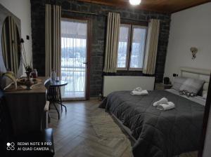 a bedroom with a bed with two towels on it at Bujtina Vila Dodo in Leskovik