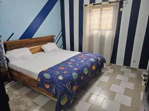 Una cama o camas en una habitación de Résidence meublée Yamoussoukro