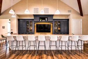 a large kitchen with a bar with white stools at Arbor-Lyn --- 19319 Loblolly Cir. in The Plantations