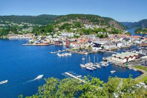 an aerial view of a harbor with boats in the water at Leilighet toppetasje, Flekkefjord in Flekkefjord