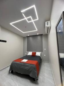 a bedroom with a bed in a room at Hotel Tonaka in Santo Domingo de los Colorados