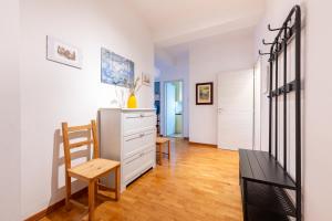 a living room with a dresser and a chair at Blu&Yellow Apartment in Parma Station in Parma