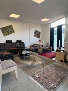 a living room with a couch and a tv at Menzel Ferienwohnungen in Beckingen