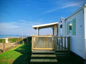 a house with a porch and stairs to the beach at Le champ de vagues à Le Portel in Le Portel